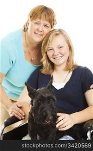 Mother, disabled teen daughter and their Scotty dog pose for a portrait. White background.
