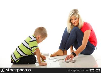 mother doing playing puzzle toy together with her son on floor isolated on white background
