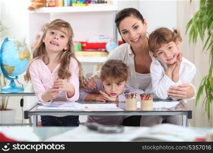 Mother drawing with three daughters