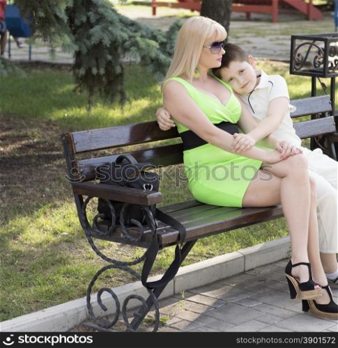 mother embraced the son sitting on a bench