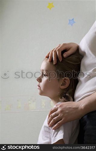 Mother embracing daughter