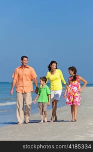 Mother, Father and Children Family Walking At Beach