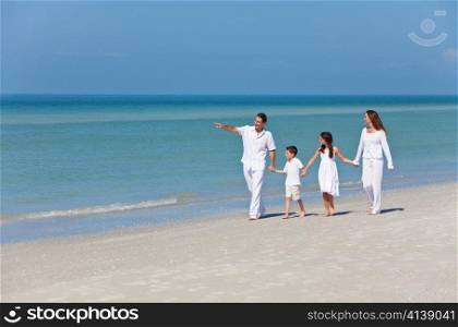 Mother, Father and Children Family Walking on Beach