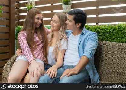 mother, father and daughter sitting on sofa and discuss or consult together in garden home, family problem concept