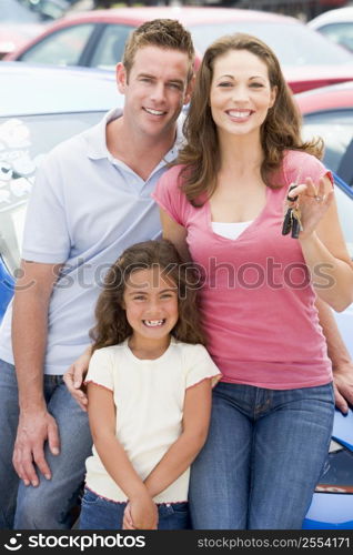Mother Father and young daughter shopping for a new car