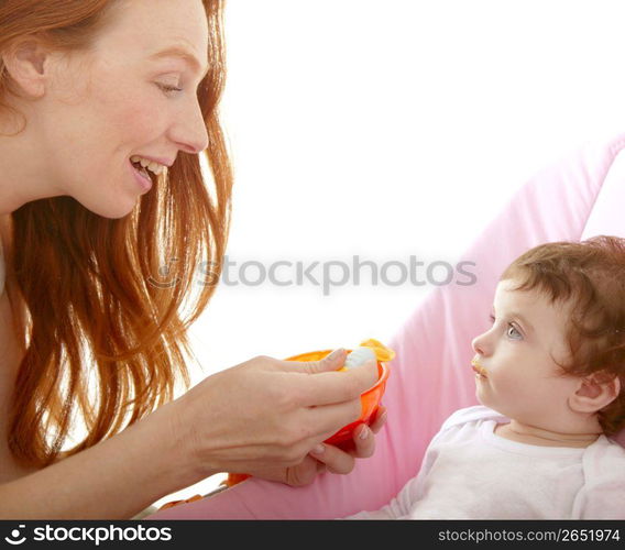 mother feeding baby yellow spoon white background