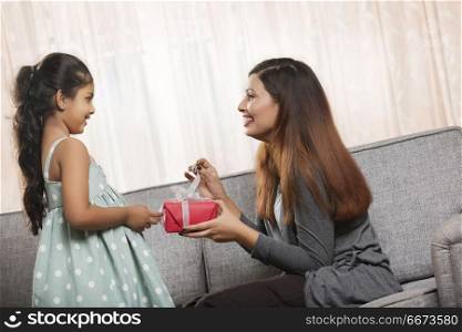Mother giving present to daughter