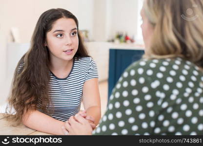 Mother Having Serious Conversation With Teenage Daughter At Home