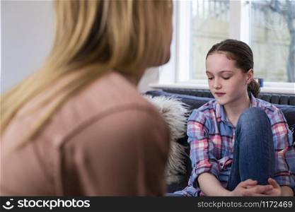 Mother Having Serious Conversation With Worried Young Daughter At Home