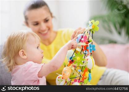 Mother helping baby made Easter decoration