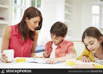 Mother Helping Children With Homework
