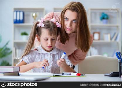 Mother helping her daughter to do homework
