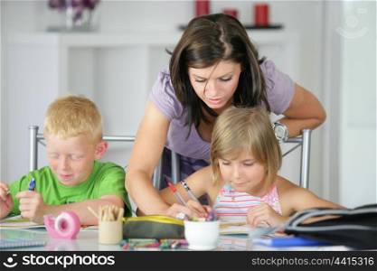 mother helping her kids with the homework