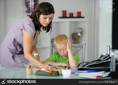 mother helping his son with the homework