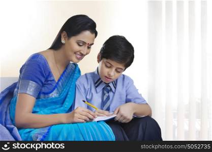 Mother helping son study