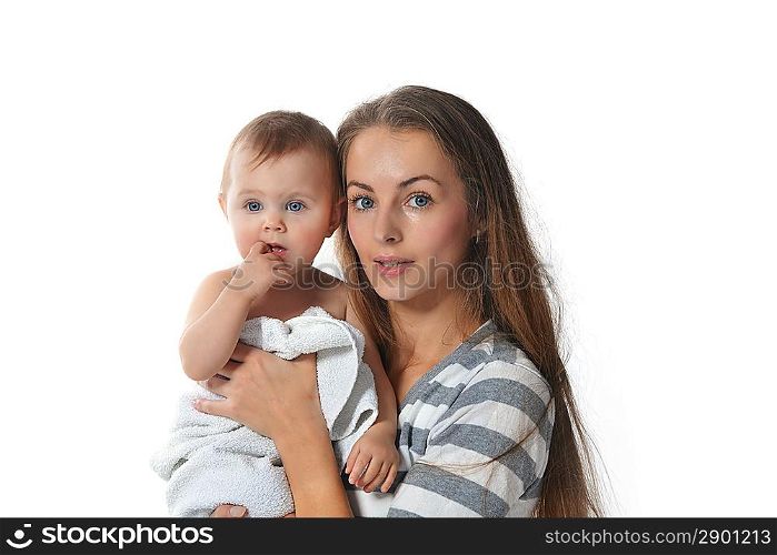 mother holding cute baby in white towel at home
