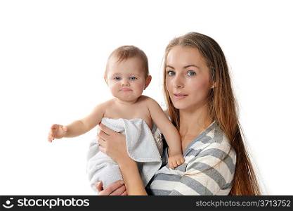 mother holding cute baby in white towel at home