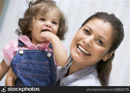 Mother holding IVF child smiling