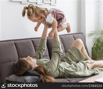 mother holding up child