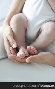 Mother holds baby boys feet