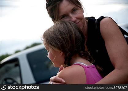 Mother hugging daughter in Belize