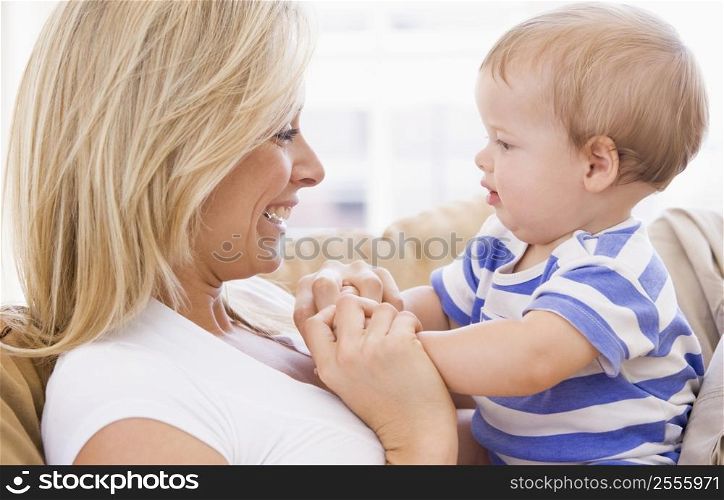 Mother in living room holding baby smiling