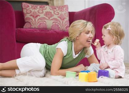 Mother in living room with baby eating banana and smiling