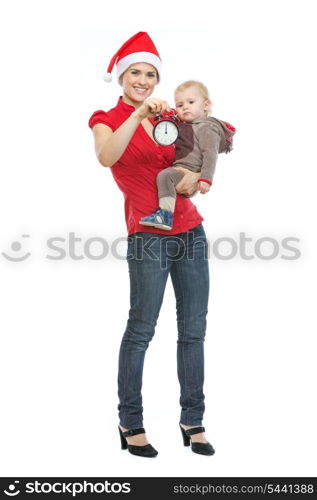 Mother in Santa&rsquo;s hat holding baby and alarm clock