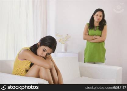 Mother looking at sad daughter