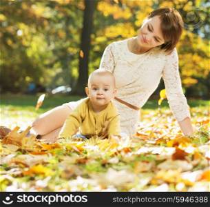 Mother lying on the leaves with baby