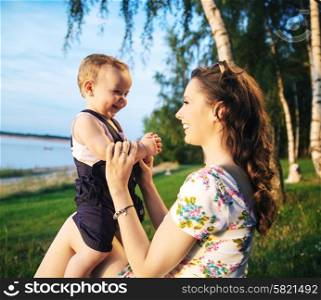 Mother making her lovely child laughing