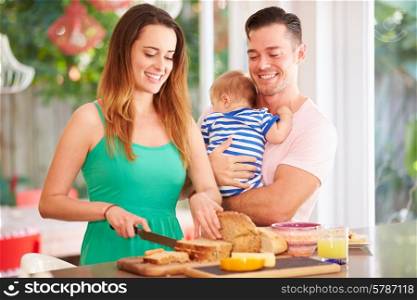 Mother Making Snack For Family In Kitchen
