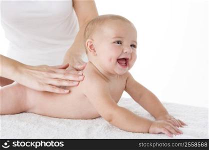 Mother massaging baby