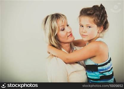 Mother mom woman and kid little girl daughter in studio. Family love.. Mother and little girl kid in studio.