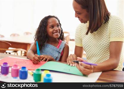 Mother Painting Picture With Daughter At Home