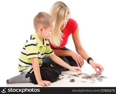 mother playing puzzle together with her son on floor isolated on white background