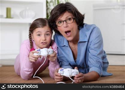 Mother playing vide-games with daughter