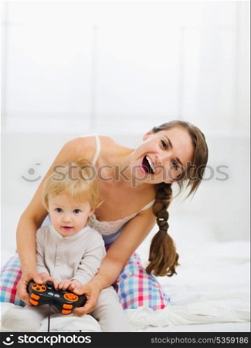 Mother playing with baby on console