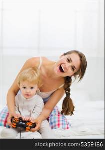 Mother playing with baby on console