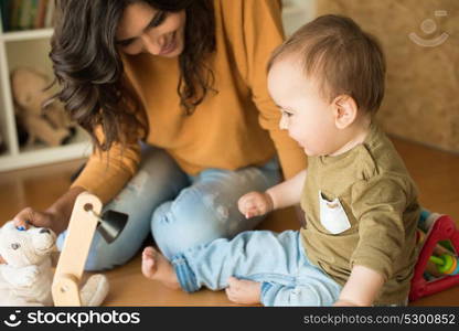 Mother playing with her baby - education methods concept