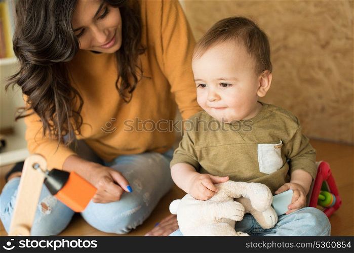 Mother playing with her baby - education methods concept