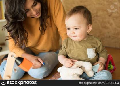 Mother playing with her baby - education methods concept