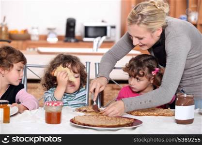 Mother preparing breakfast for kids