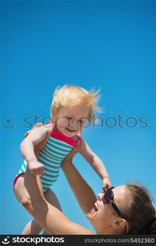 Mother raises baby in air