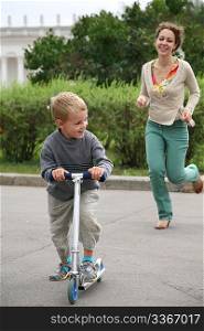mother runs after the son on the bicycle