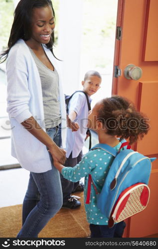 Mother Saying Goodbye To Children As They Leave For School