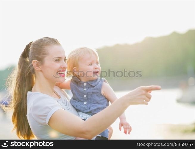 Mother showing something to baby
