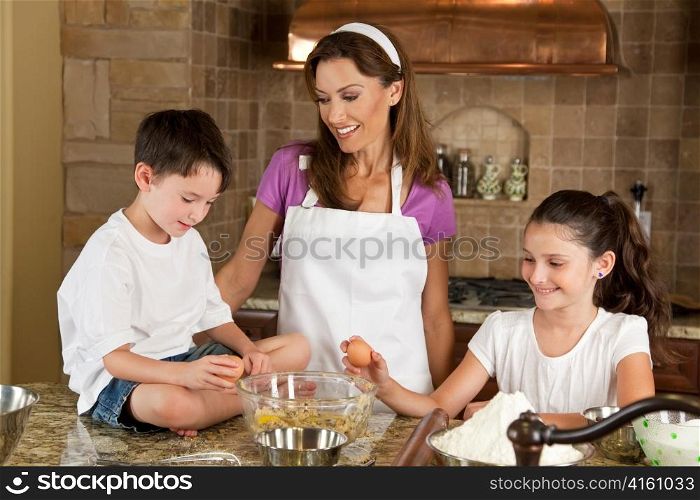 Mother, Son & Daughter Family In Kitchen Cooking Baking