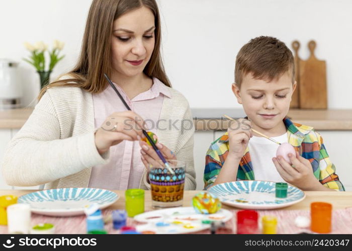 mother son home painting eggs