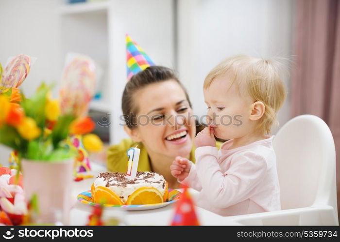 Mother spending fun time with baby on birthday party